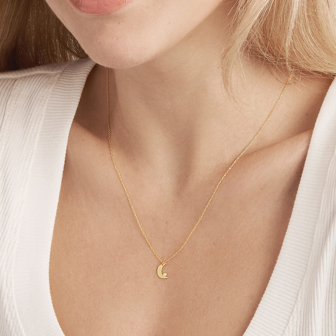 14K gold diamond bezel half moon necklace, close-up of the crescent design