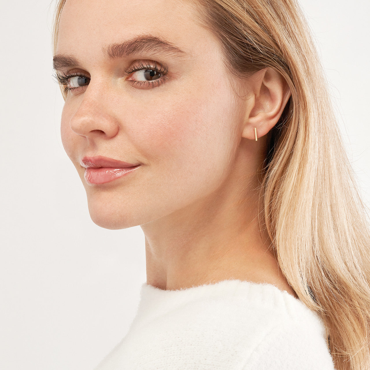 Mini staple bar earrings in gold with a sleek, modern design and minimalist aesthetic, perfect for everyday wear.