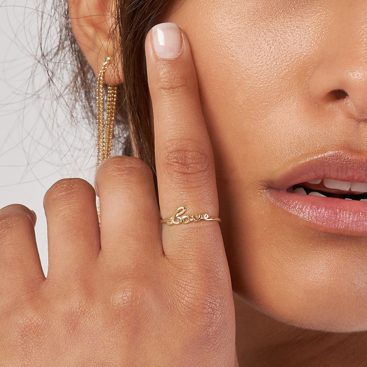14K gold cursive love ring, elegant script on a soft background