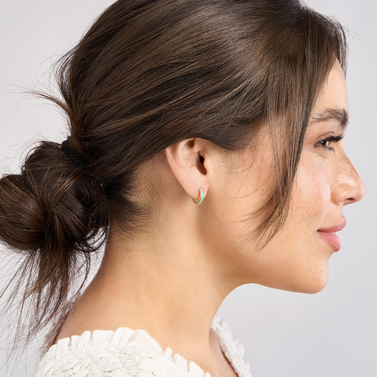 Light turquoise enamel baby hoop earrings with a sleek, simple design, perfect for little ones.